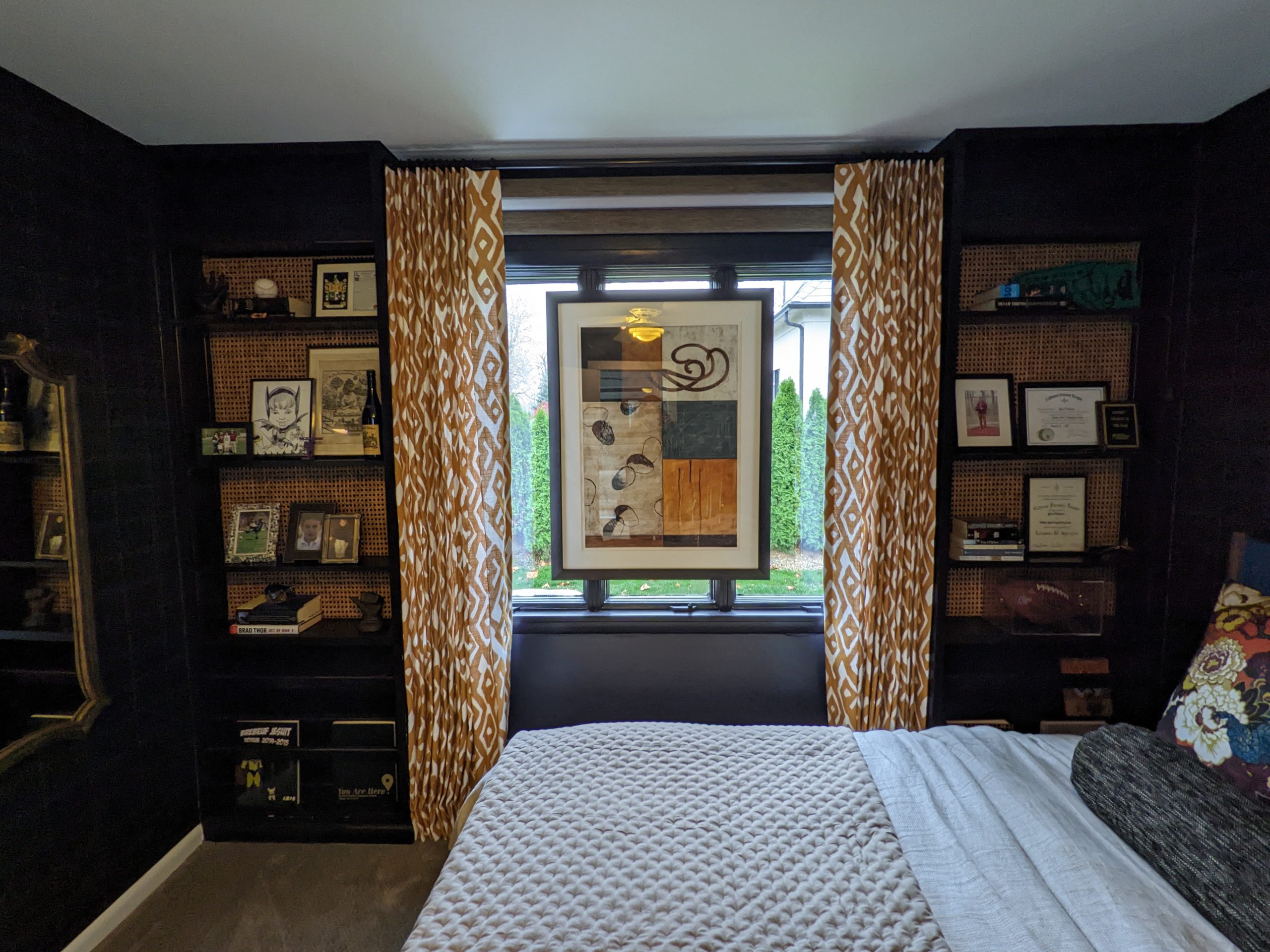 bedroom with dark walls and high contrast drapes