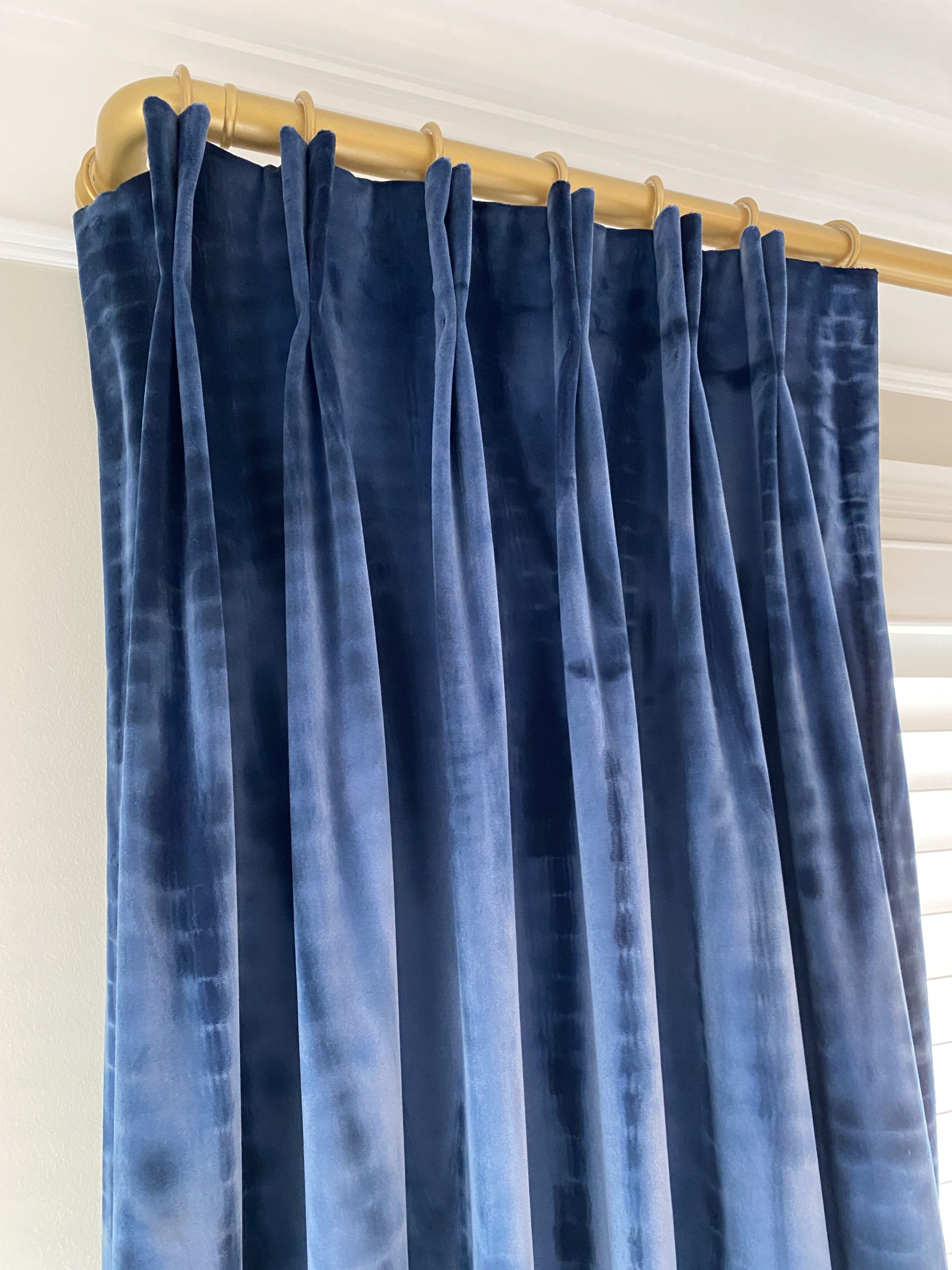 Blue velvet drapes on gold french return 