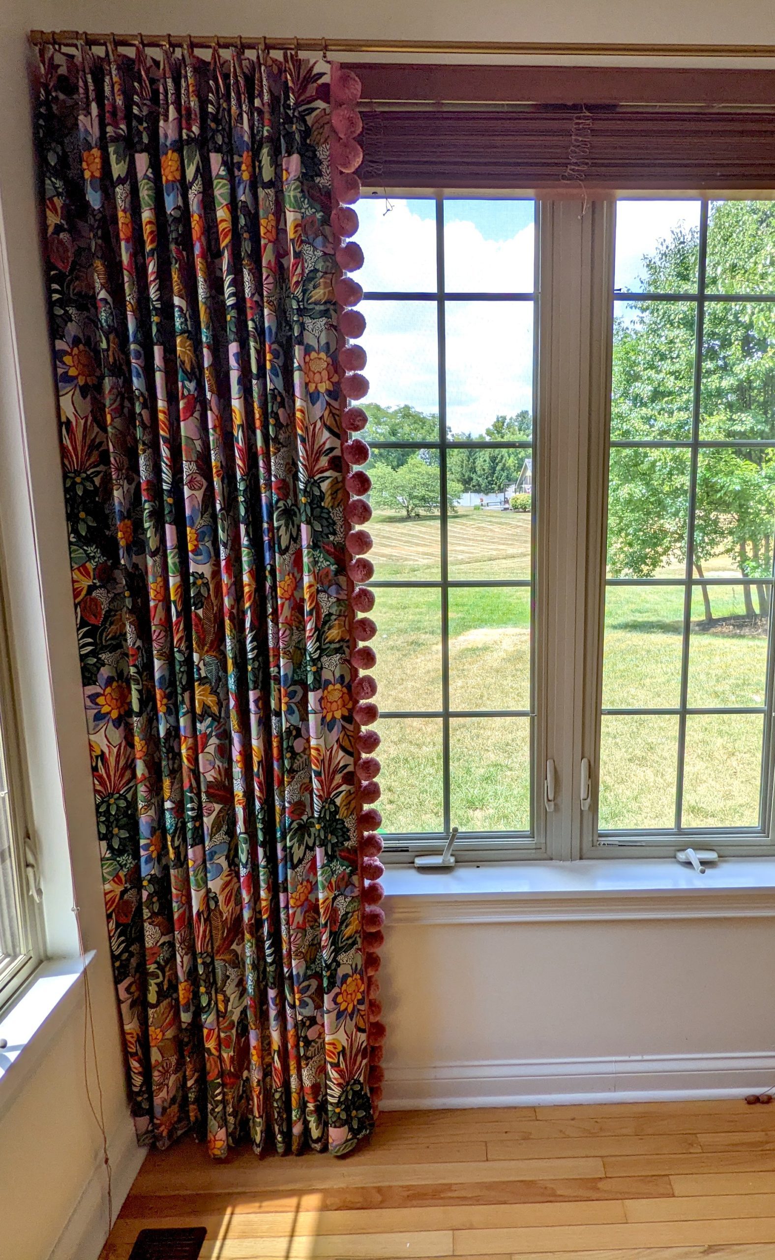 Colorful floral drapes with pom pom trim