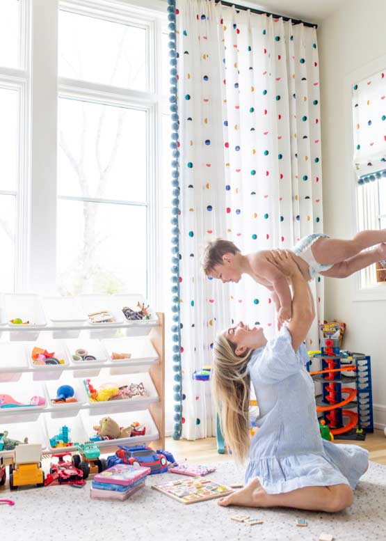 Woman holding up child